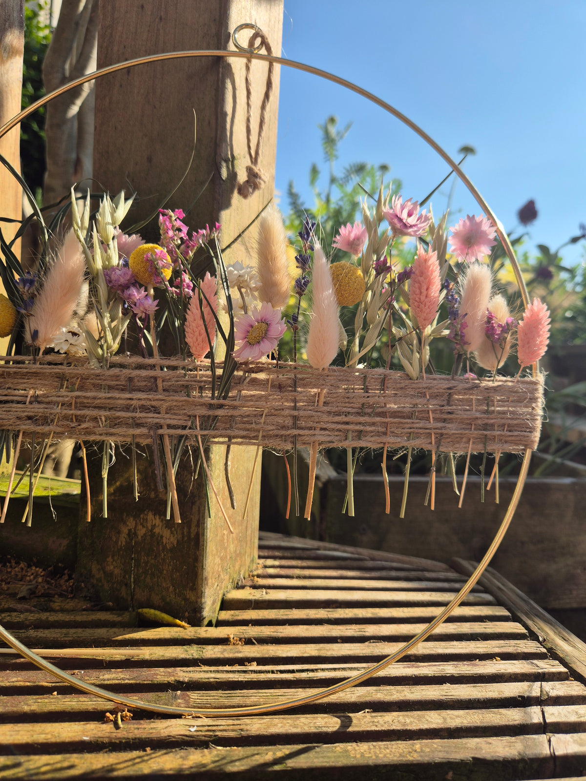 Dried flowers inspired by a summer meadow in a golden hoop
