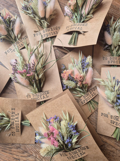 Kraft paper envelopes with floral designs and text on a wooden surface