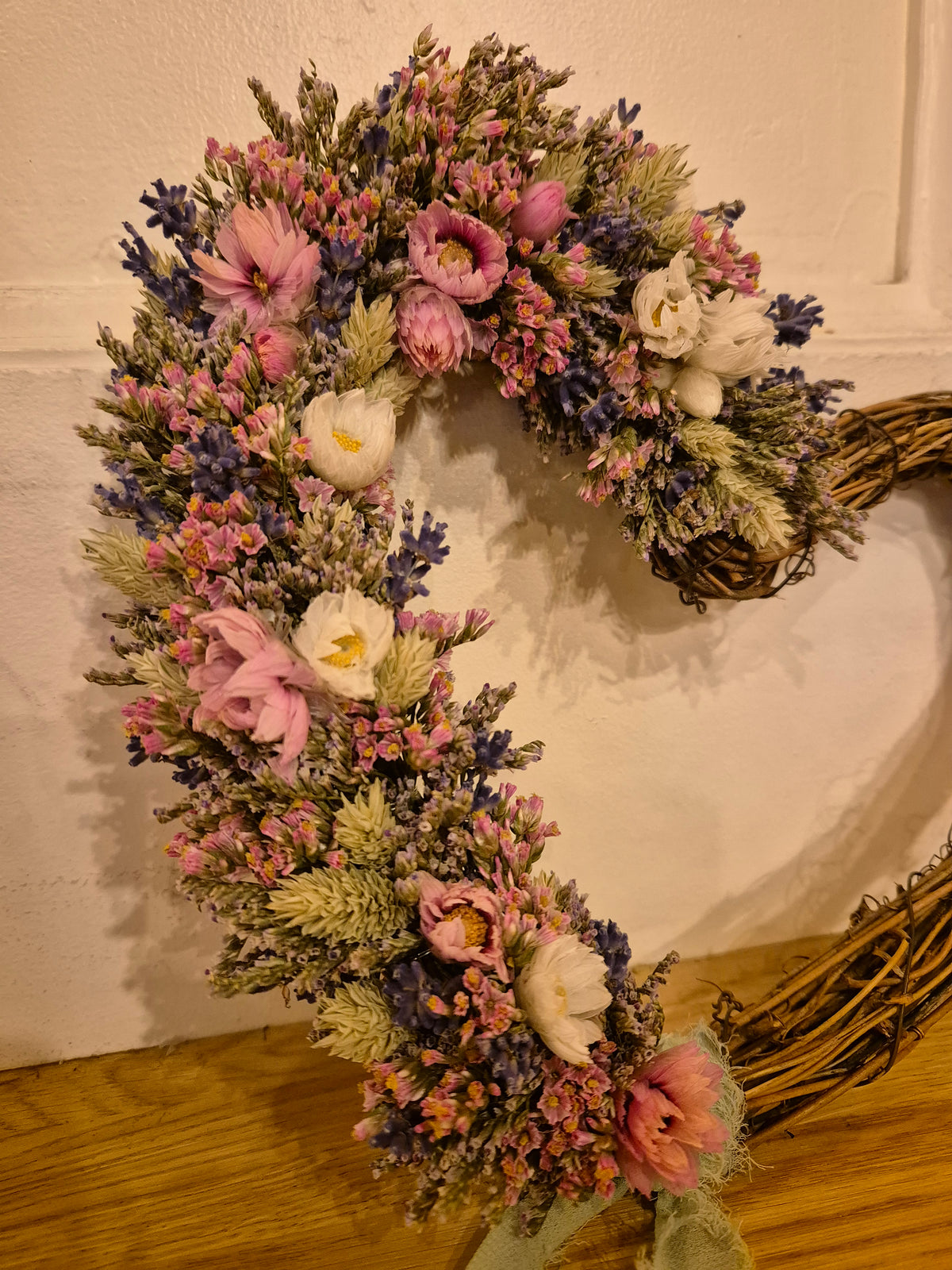 Dried flower heart shaped wreath with pink, blue and white hues