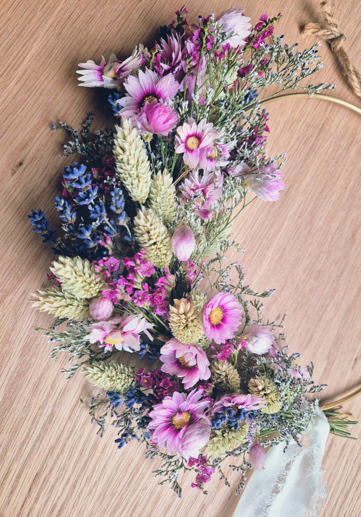 Dried flower wreath picture with a gold hoop and ribbon