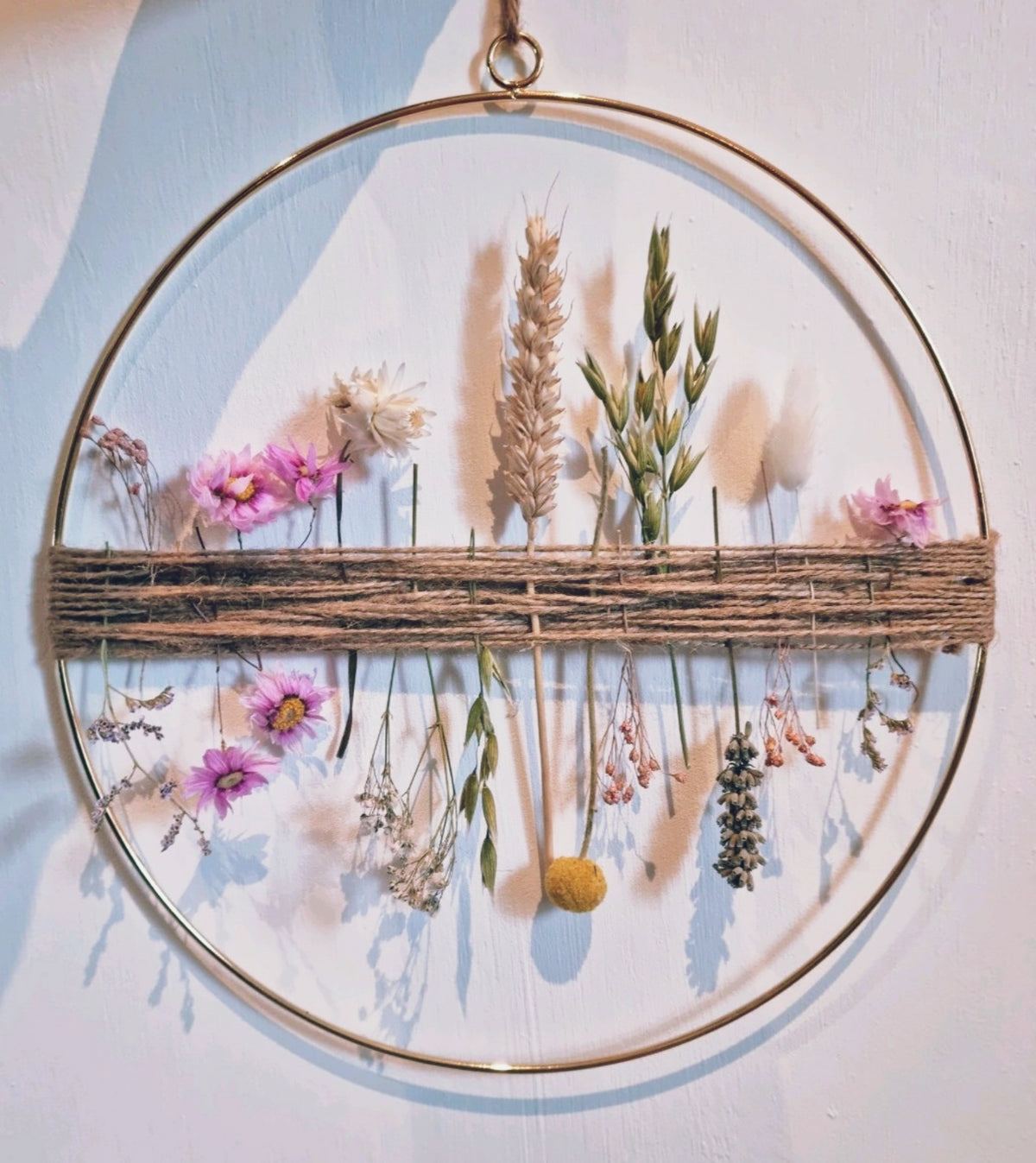 Dried Flower Hoop of pink, green and white hues inspired by spring and with a neutral background